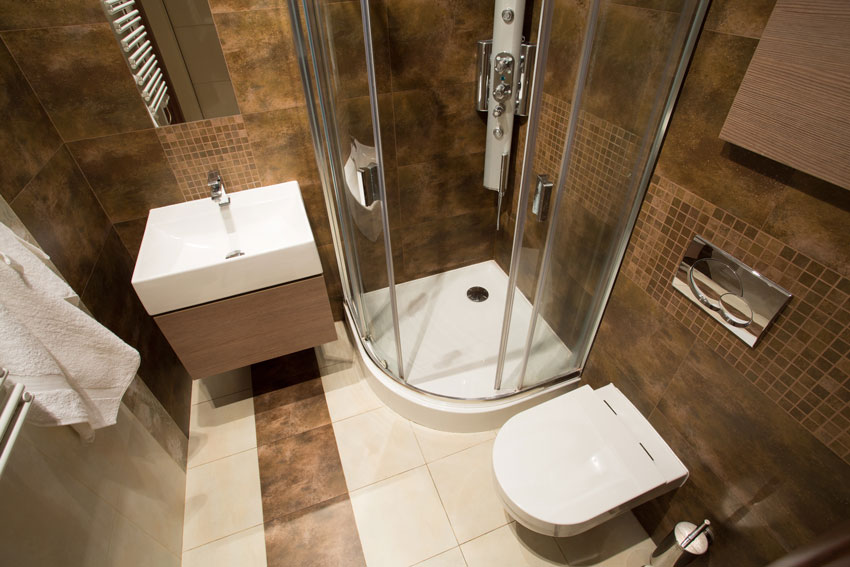 petite salle de bain bien agencée avec toilette, lavabo et cabine de douche.