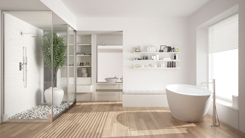 Salle de bain moderne lumineuse, murs blancs et sol en imitation parquet, grande cabine douche avec plante verte.