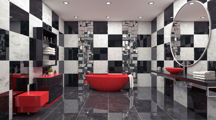 salle de bain design avec carrelage à carreaux noir et blanc, baignoire rouge, sanitaire rouge, lavabo rouge sur meuble noir.