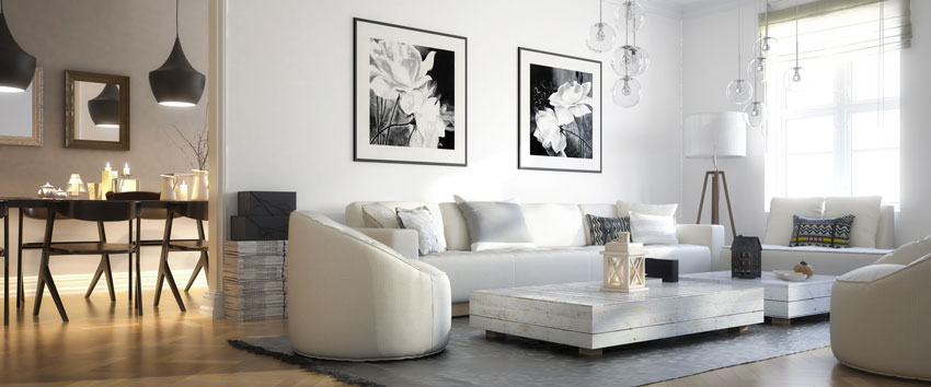 Mobilier minimaliste, canapé blanc avec photos noir et blanc, grand tapis gris.