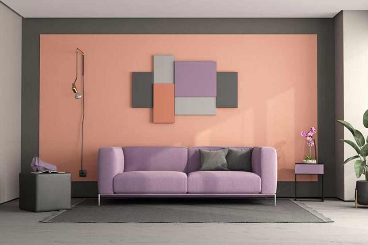 Salon avec les couleurs gris, rose et violet prédominantes.